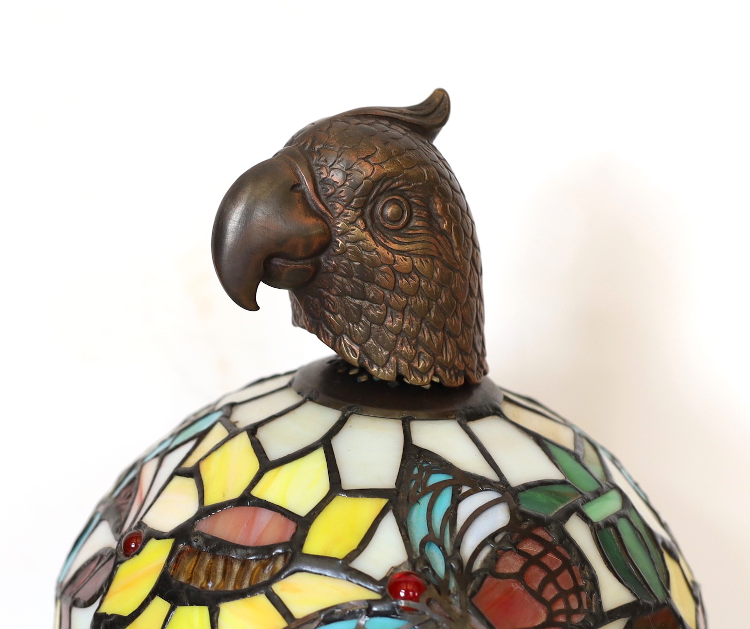 A bronze, stained glass and marble table lamp modelled as a flowering tree with parrot head, height 44cm